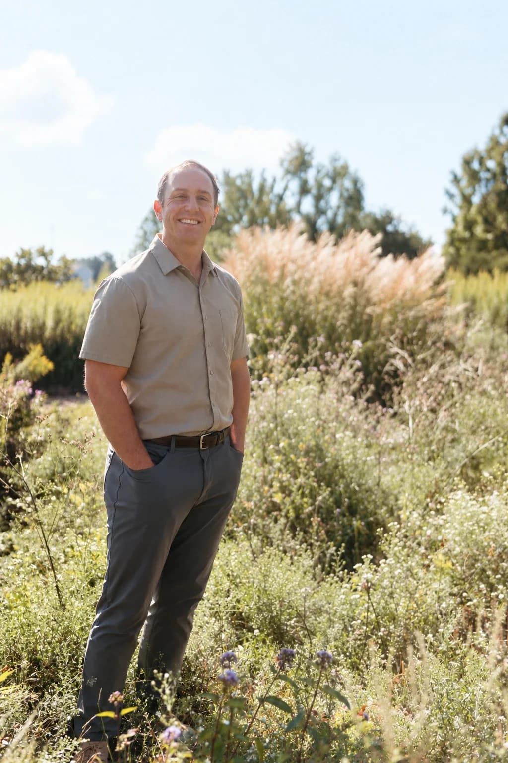 Daniel Tagge, MD, standing in a meadow